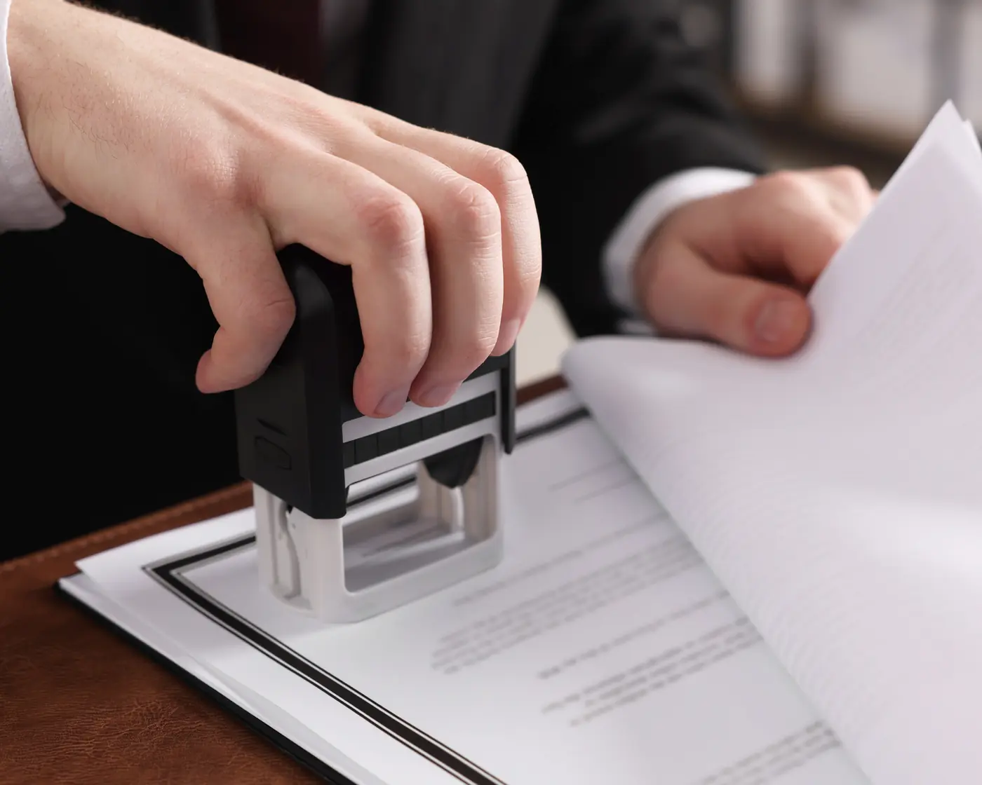 Hands stamping an official document